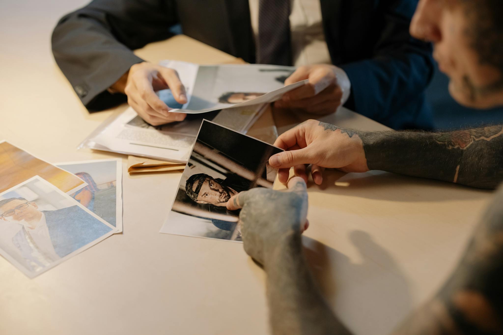 Detective going through suspect photos during an investigation meeting.